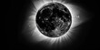 A black and white image of a solar eclipse, where the completely darkened Sun is surrounded by a bright corona, radiating into the dark space.