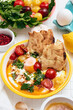 Cilbir or Turkish Eggs in white bowl. Turkish cuisine concept.