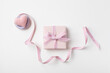 Holiday concept greeting card for Birthday, Woman or Mothers Day. Pink heart, ribbon and gift box top view. Flat lay.
