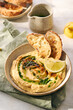 Delicious homemade hummus with lemon, paprika, olive oil and microgreens. Vegetarian Middle Eastern dish