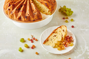 Poster - Delicious homemade grape sponge cake with noble mold cheese on a stone background.