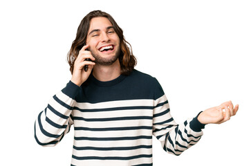 Wall Mural - Young handsome man over isolated background keeping a conversation with the mobile phone with someone