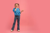 Fototapeta  - Girl posing with peace sign on pink background