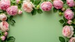 Spring flower border made of pink roses and peonies on pastel green background. Top view, flat lay.	
