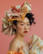 Avantgarde Fashion shooting. Asian Model wearing clothes made of old newspapers for recycling on a pink pastel background. 