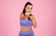 Focused woman exercising with dumbbells