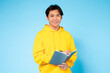Guy reading a book, bright yellow hoodie