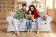 © Prostock-studio - Happy family with tablet on a couch