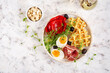 English breakfast. Boiled egg, jamon, waffles and green herbs. Top view, flat lay