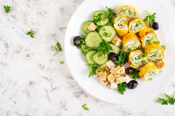 Wall Mural - Healthy breakfast. Roll omelette, feta cheese and cucumber salad. Keto, ketogenic lunch. Top view