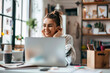 © Tjeerd - Confident happiness young woman working on laptop or notebook in her office. Beautiful Freelancer Woman working online at her home.