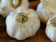 close-up of a whole garlic head showcases its papery skin and individual cloves, each tightly packed within. The bulb emanates a pungent aroma, characteristic of fresh garlic, 