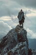 A man standing on top of a mountain with a stick. Ideal for outdoor and adventure concepts