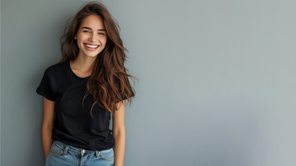 Canvas Print - Brunette young woman wear black t-shirt smile isolated on grey background