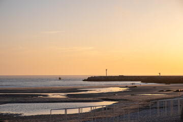 Fototapete - sunset landscape of a ship entering a port