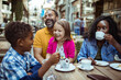 © Vorda Berge - Happy multiethnic family enjoying time at a cafe together