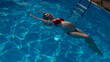 © Михаил Решетников - Top view of pregnant woman floating in pool in red bikini.