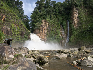 Wall Mural - A waterfall hidden deep in a tropical rainforest of Indonesia	
