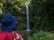 A woman explores the tropical rainforests to find a hidden waterfall