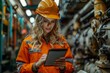 © Larisa AI - A focused female in safety gear operating a tablet amid industrial machinery, representing technology in manufacturing