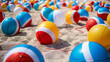 A colorful array of beach balls scattered across the sand, waiting to be tossed and kicked by eager beachgoers.