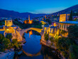 © dudlajzov - Sunset view of the old Mostar bridge in Bosnia and Herzegovina