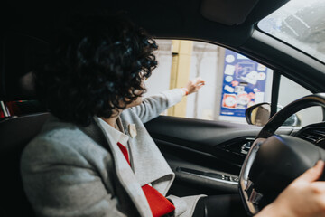 Businesswoman driving in the city, focused and pointing to navigate urban traffic