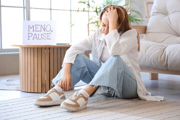 Wall Mural - Upset mature woman experiencing menopause at home