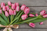 Fototapeta Tulipany - bouquet of tulips on a wooden background