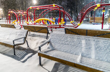 Benches Under The Snow On A Winter Evening At The Playground.