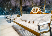 Benches Under The Snow On A Winter Evening At The Playground.