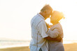 © CandyRetriever  - Happy family Asian senior couple having romantic moments dancing together at tropical beach at summer sunset. Elderly husband and wife enjoy outdoor lifestyle travel nature ocean on holiday vacation.