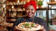 An obese black woman of mature age happily holding a pizza on a plate