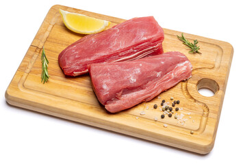 Wall Mural - Fresh tuna Fish steak on a wooden cutting serving board isolated on a white background