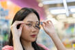 © Art_Photo - Portrait of smiling beauty fashion happy woman trying and testing wearing new modern good quality eyeglasses with optician at glasses shop.eyewear and eye health concept