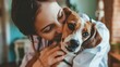 © Janie - A caring veterinarian shares a tender and affectionate moment with a beagle dog, showcasing the bond between pets and their caregivers.