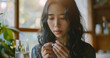 young woman of Asian descent, girl hand holding pill capsule, pain-relieving medication for stomach ache, headache, pain for treatment, take medication or vitamin and glass of water at home, pharmacy 