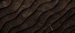 A close up of a brown leather texture resembling waves, reminiscent of the formation of hardwood flooring. The tints and shades mimic the natural patterns found in tree bark and soil
