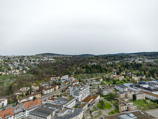 Wall Mural - Aerial view over Swiss City of Zürich with hospital buildings and woodland in the background on a cloudy spring day. Photo taken April 7th, 2024, Zurich, Switzerland.