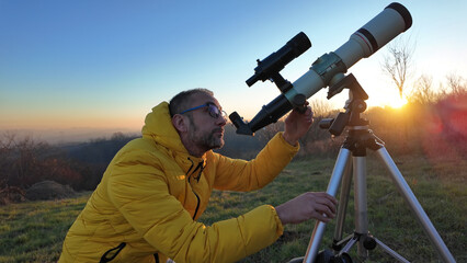 Wall Mural - Amateur astronomer observing skies with a telescope.