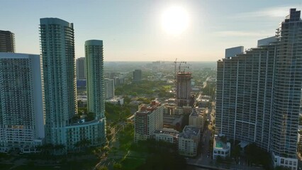 Wall Mural - New developing residence in American urban area. Tower cranes at industrial construction site in Miami, Florida. Concept of housing growth in the USA