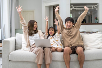 Wall Mural - Father and mother with asian kid girl learn on laptop computer reviewing lesson study with online education e-learning.student look for educational knowledge in homeschool at home.Education