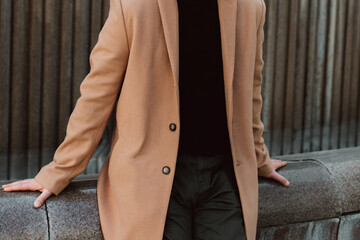 Canvas Print - Beige brown men's coat, pants and black turtleneck. Classic street outerwear. Fashion details