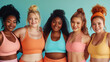 Group of women of different ethnicities wearing sportswear, looking at camera, smiling confidently. Feminism, empowerment and well-being.