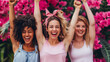 Group of girls of different ethnicities smiling together with their arms raised, celebrating their friendship.
