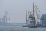 Fototapeta Morze - SHIPYARD - Industrial landscape in foggy weather