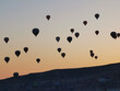 A Cappadocian morning with sunrise on the amazing background of flying balloons. Cappadocia, Goreme street photo in minimalism style.