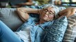 Elderly woman resting on a couch at home, feeling discomfort or pain. Casual lifestyle, healthcare moment captured. Suitable for medical and wellness content. AI