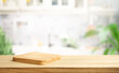 Selective focus.End grain wood counter top with cutting board on blur kitchen background