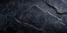 A Black Rock With A Rough Texture. The Rock Is Large And Has A Jagged Edge. The Image Has A Moody And Mysterious Feel To It